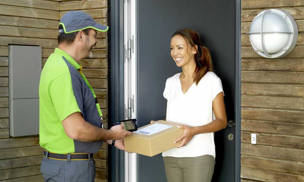 Bring courier delivers a parcel at the door.