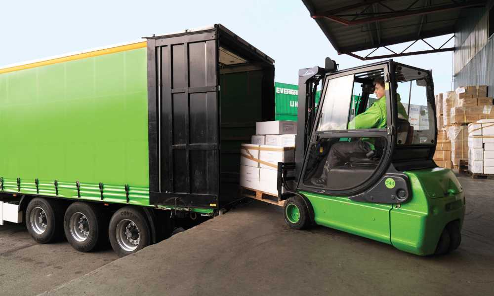 A fork lift is loading the goods onto a Bring trailer